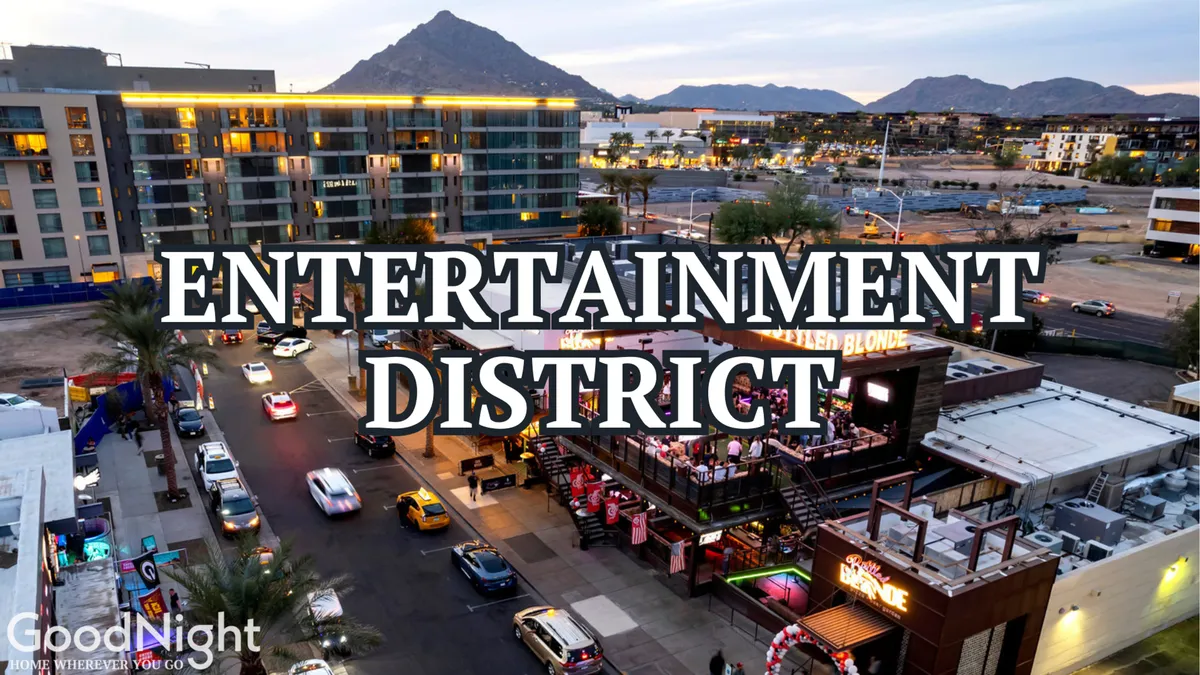 A lively exterior shot of Scottsdale's Entertainment District signage, accompanied by busy streets, cars, and an outdoor dining area bustling with activity. The setting is vibrant and hints at the area's nightlife and dining allure.